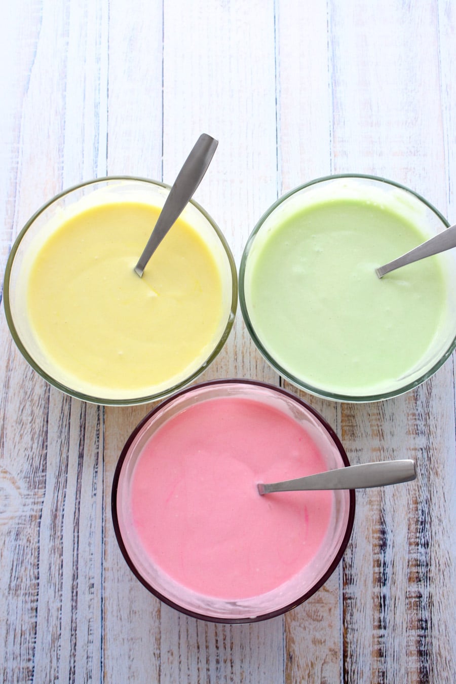 three different colors of cake mix - yellow, green, pink
