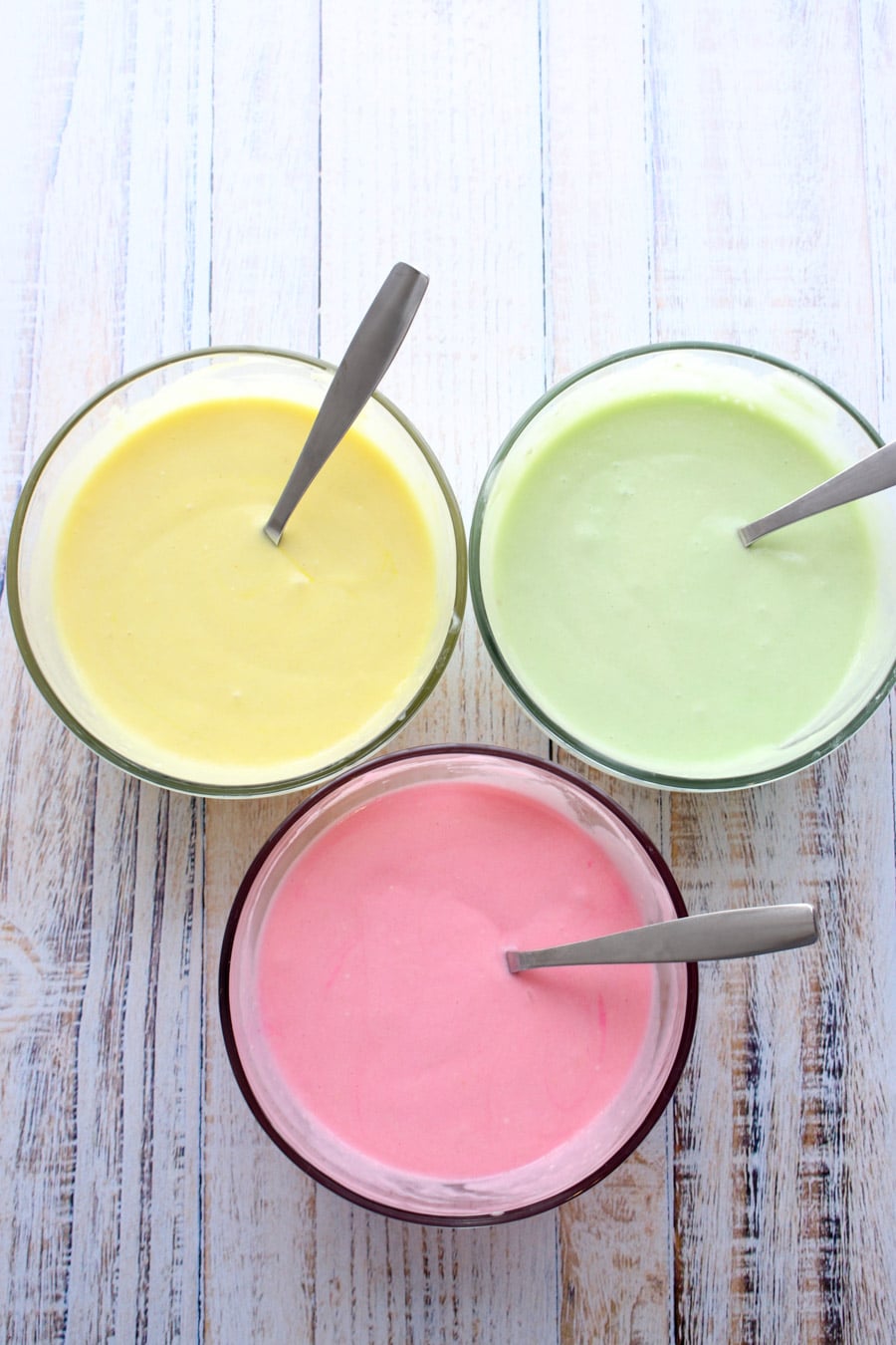 three different colors of cake mix - yellow, green, pink