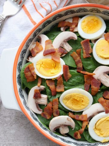 Bowl of Spinach Salad with bacon, mushrooms, eggs