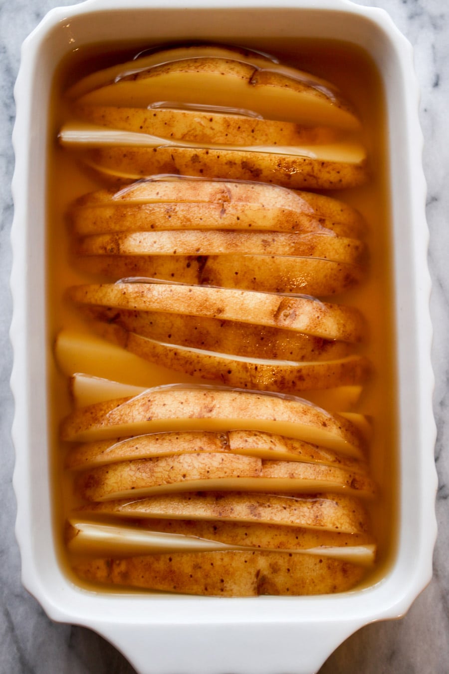 Potato slices soaking in vinegar