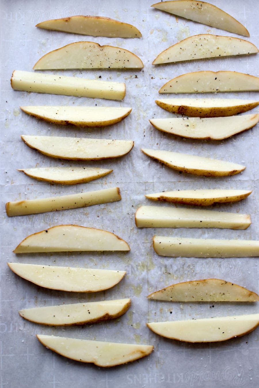 raw potatoes on a cookie sheet