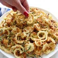 Woman's hand picking up a zucchini fry