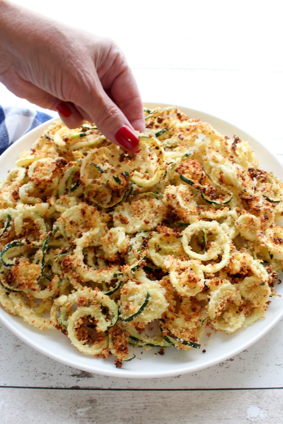 Woman's hand picking up a zucchini fry