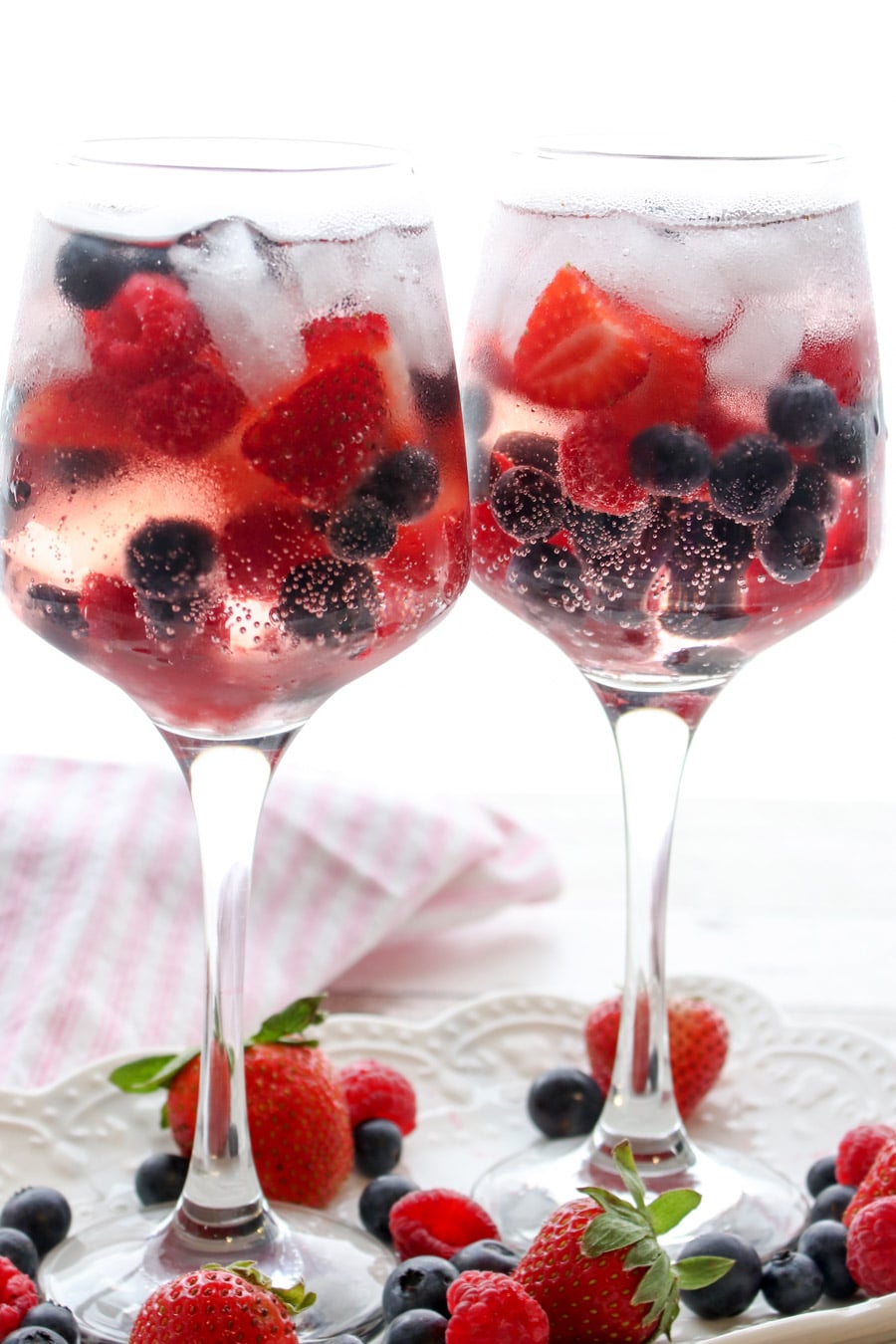 Two berry gin and tonic cocktails