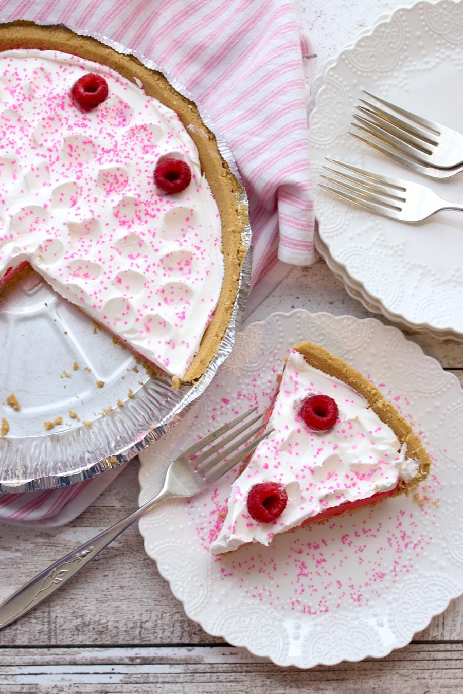 Raspberry Jello Yogurt Pie slice out of the entire pie