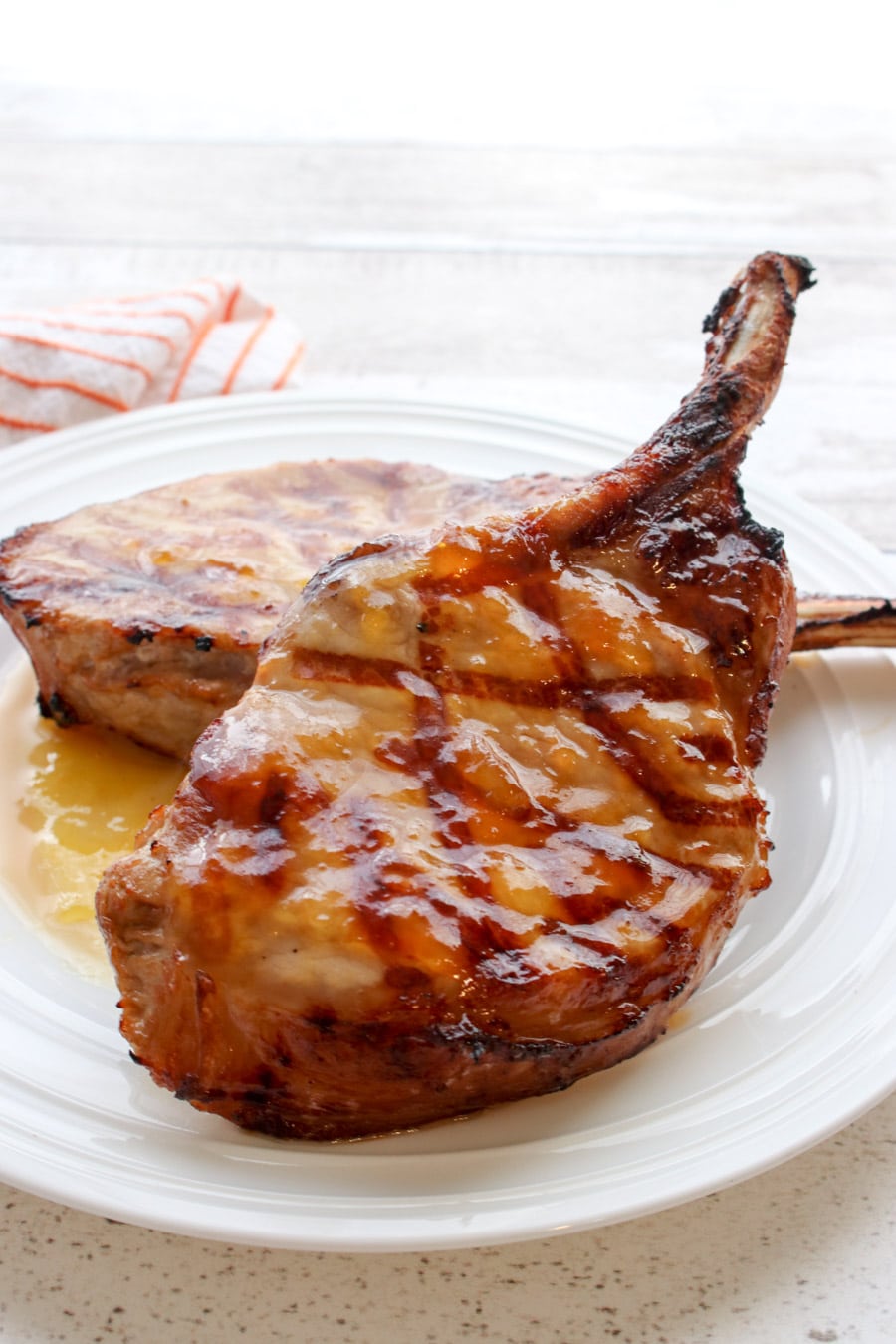 Two Pork Chops on a white plate