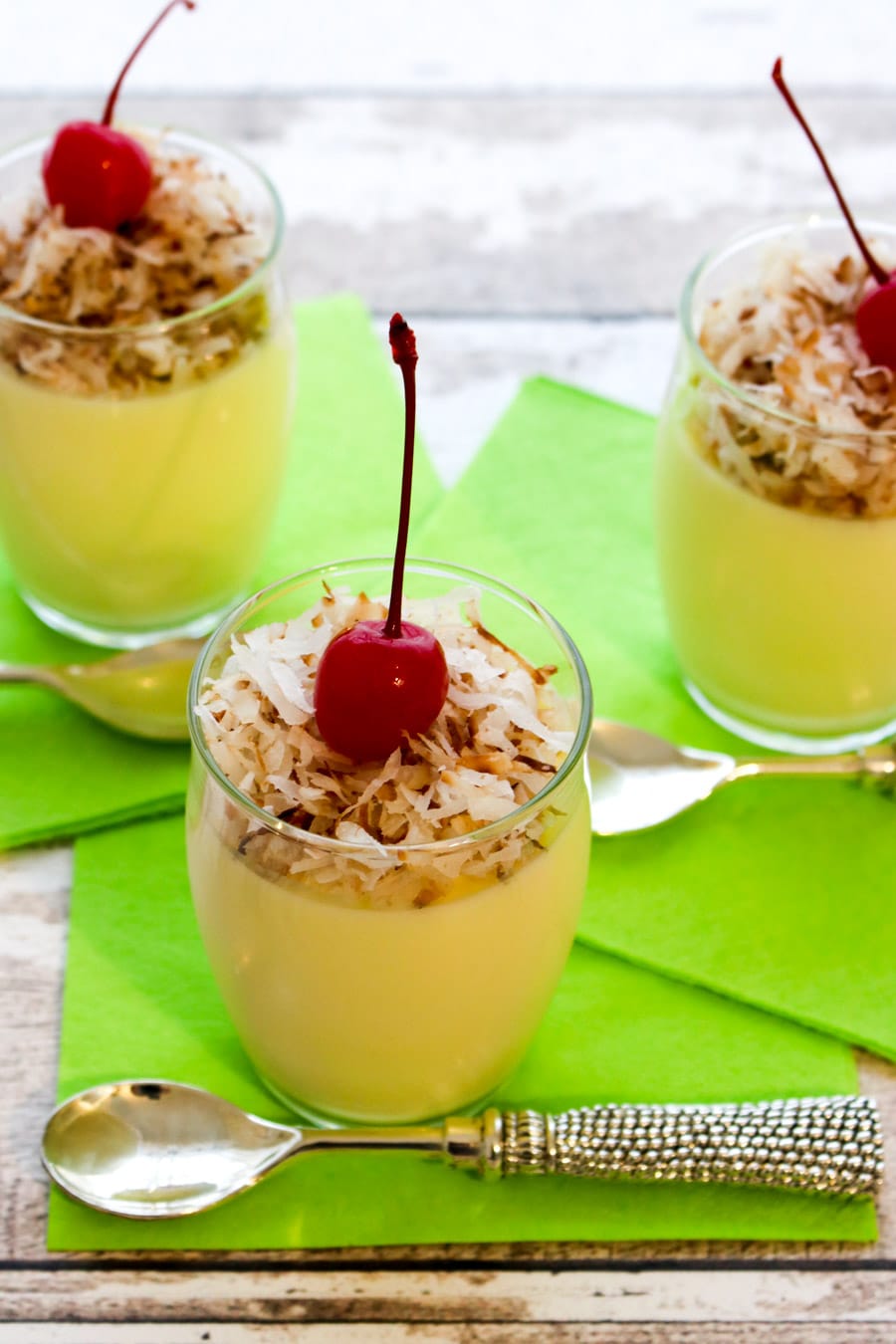 three glasses of pineapple yogurt jello parfaits