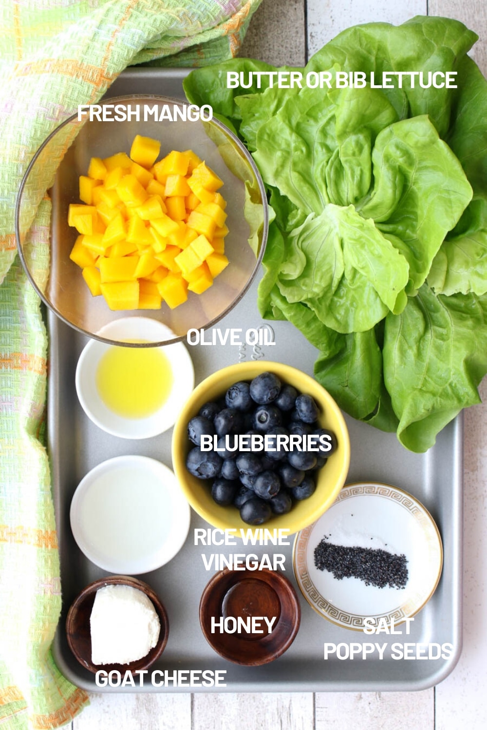 Tray with the ingredients for making mango blueberry salad