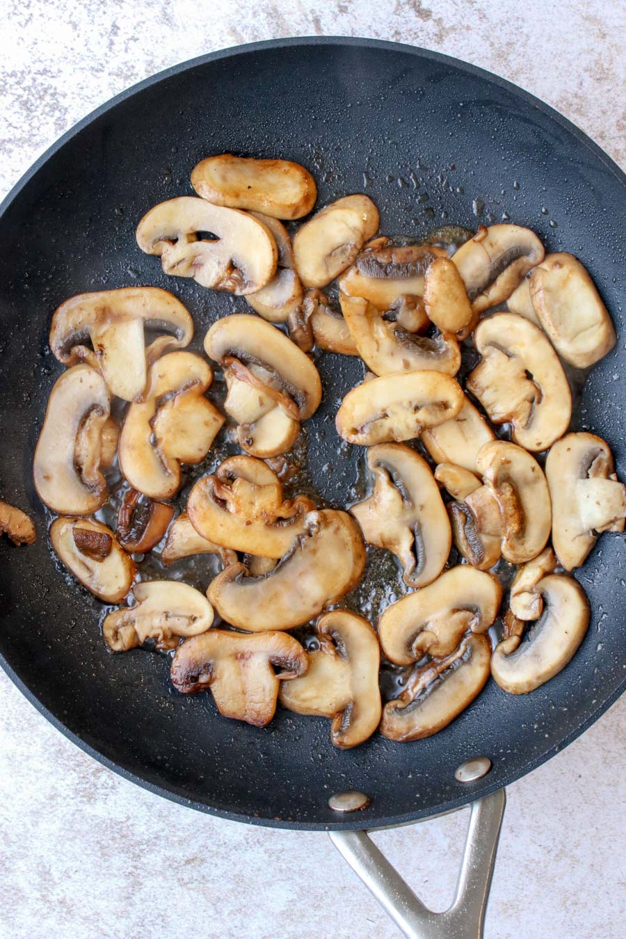 mushrooms cooking in a skillet