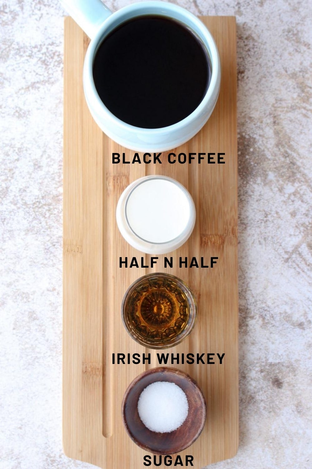 Long board with the four ingredients for making iced  Irish coffee