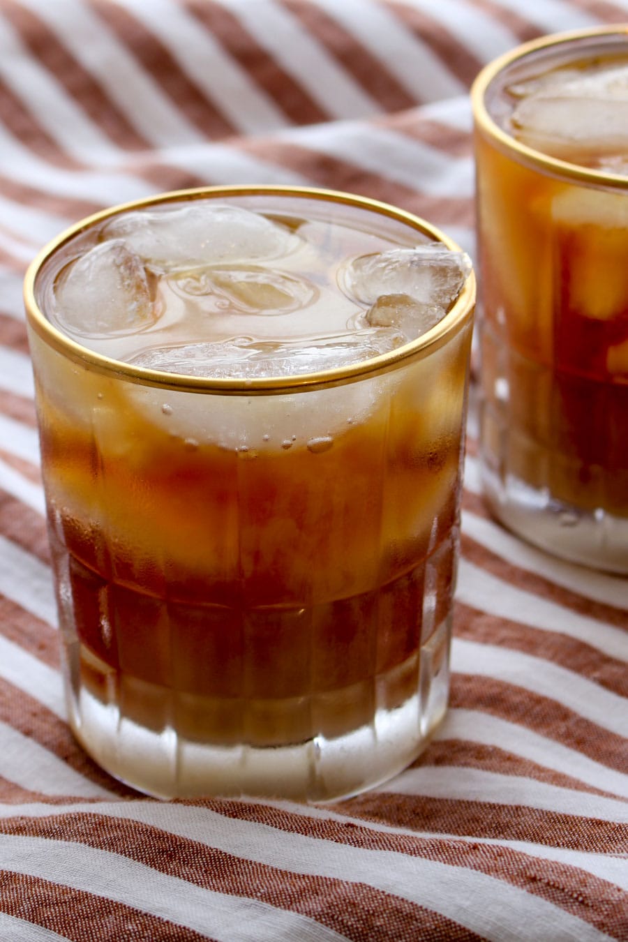 Glass of iced Irish Coffee with a striped background