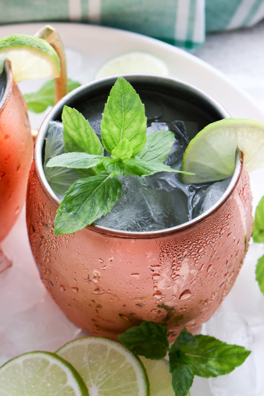 close up of a drink in a copper mug garnished with mint