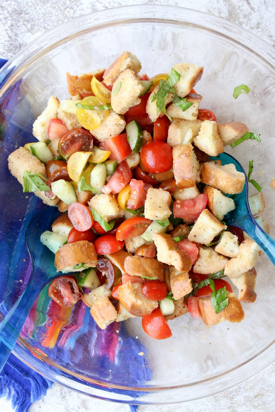 Bread Salad being tossed in a bowl