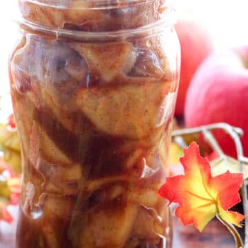 jar of apple pie filling with fall decor in background