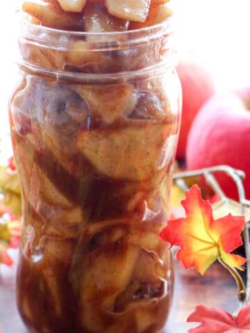 jar of apple pie filling with fall decor in background