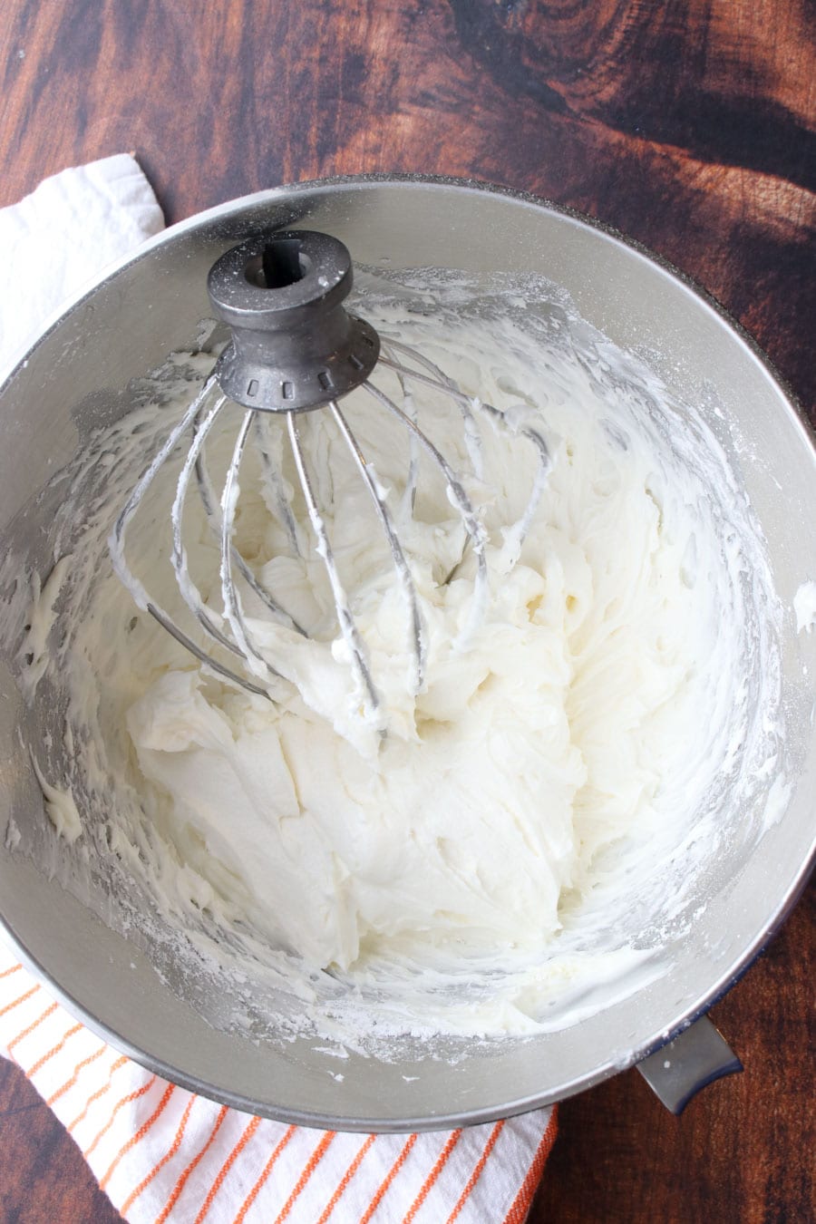 mixing bowl and whisk with prepared white cream cheese frosting