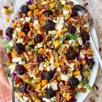 White platter with a colorful fall salad