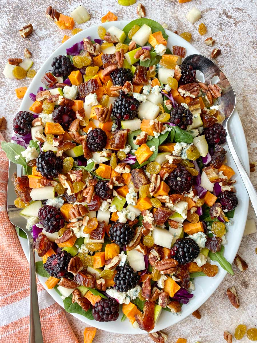 White platter with a colorful fall salad