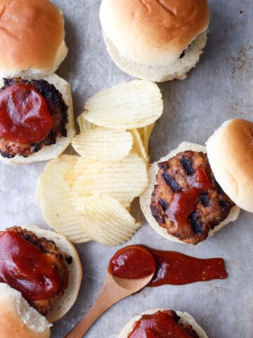 cookie sheet with meatloaf sliders and potato chips