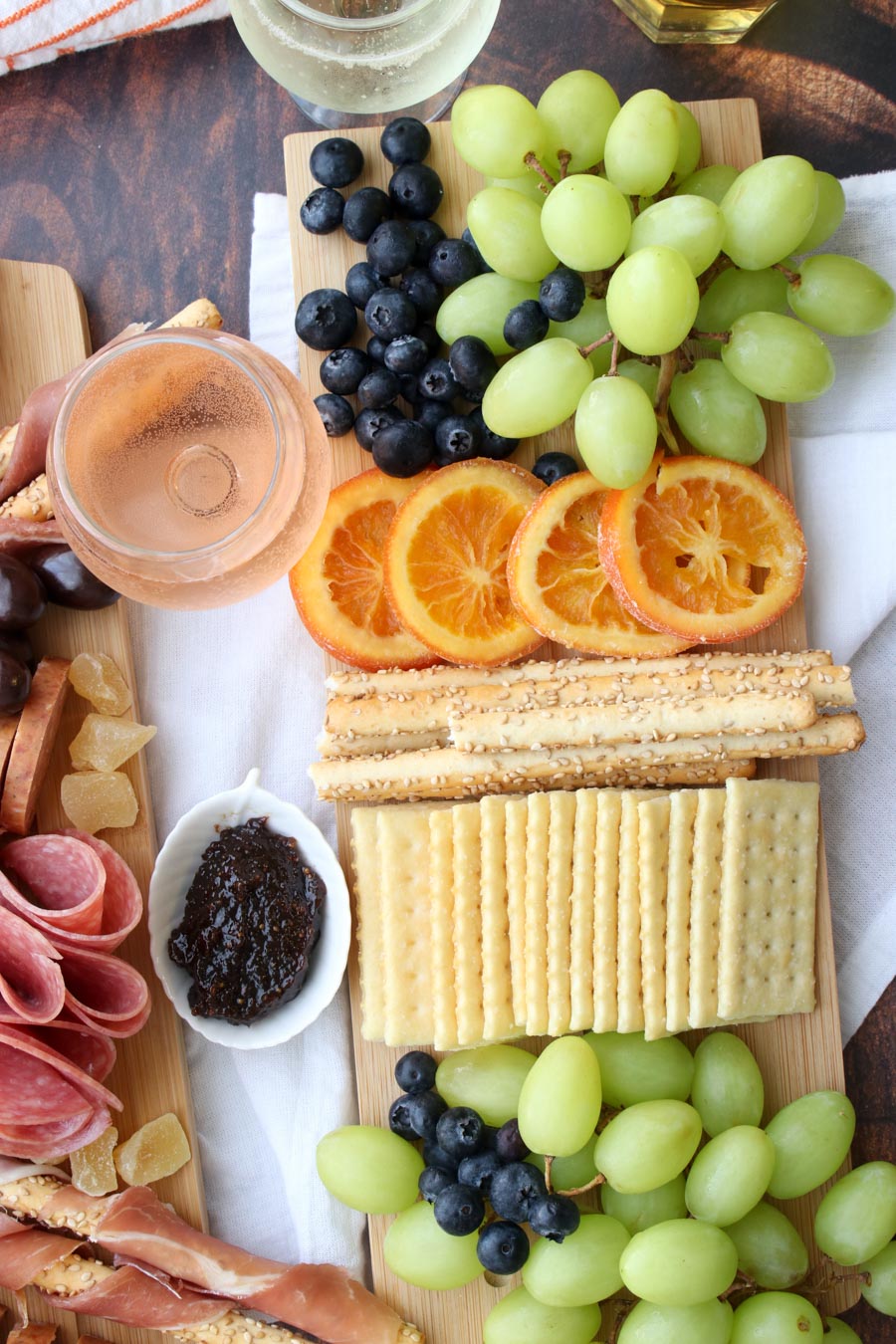 platter of crackers and fruit with wine