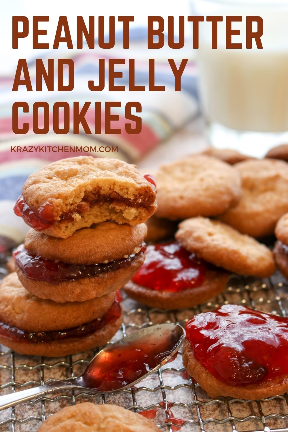 Two peanut butter cookies sandwiched together with grape jelly make the best Peanut Butter and Jelly Cookies. Crunchy, creamy, sweet - everything you remember in a delicious little three-bite cookie. via @krazykitchenmom