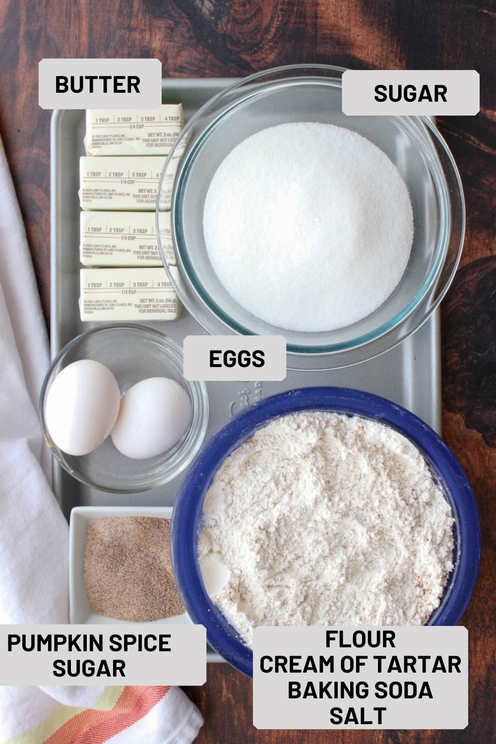 cookie sheet with the ingredients for making snickerdoodle cookies