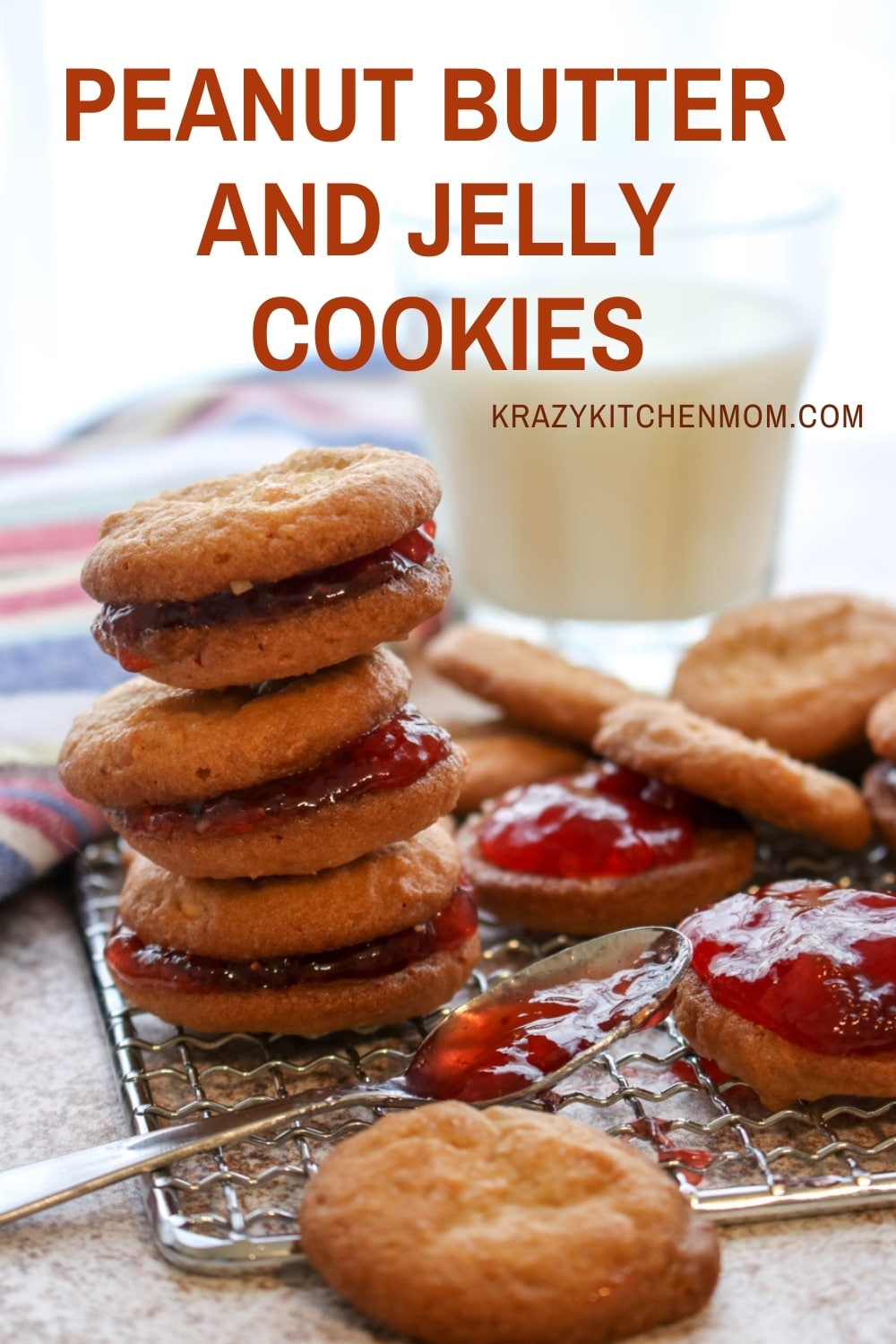 Two peanut butter cookies sandwiched together with grape jelly make the best Peanut Butter and Jelly Cookies. Crunchy, creamy, sweet - everything you remember in a delicious little three-bite cookie. via @krazykitchenmom