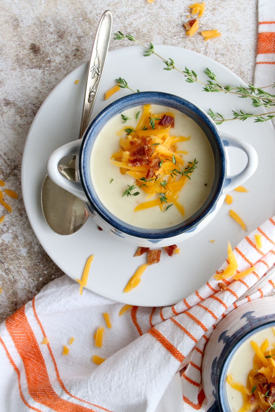 A bowl of soup topped with cheese and bacon