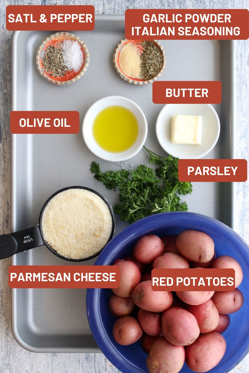 a cookie sheet with all of the ingredients to make the  roasted potatoes