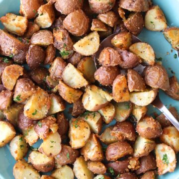 a turquoise plate full of roasted potatoes