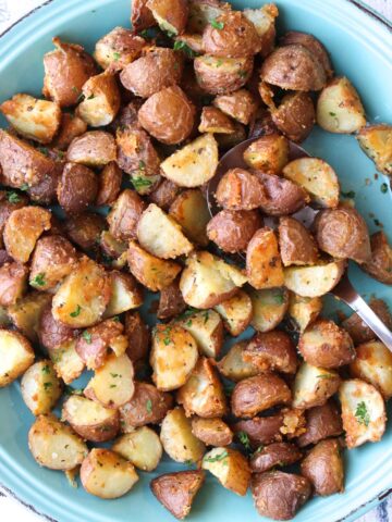 a turquoise plate full of roasted potatoes