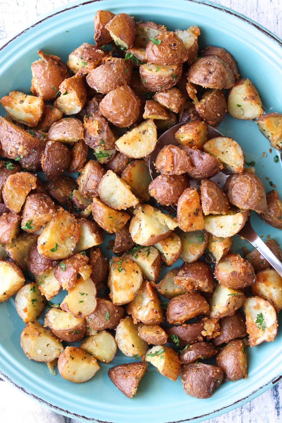 a turquoise plate full of roasted potatoes