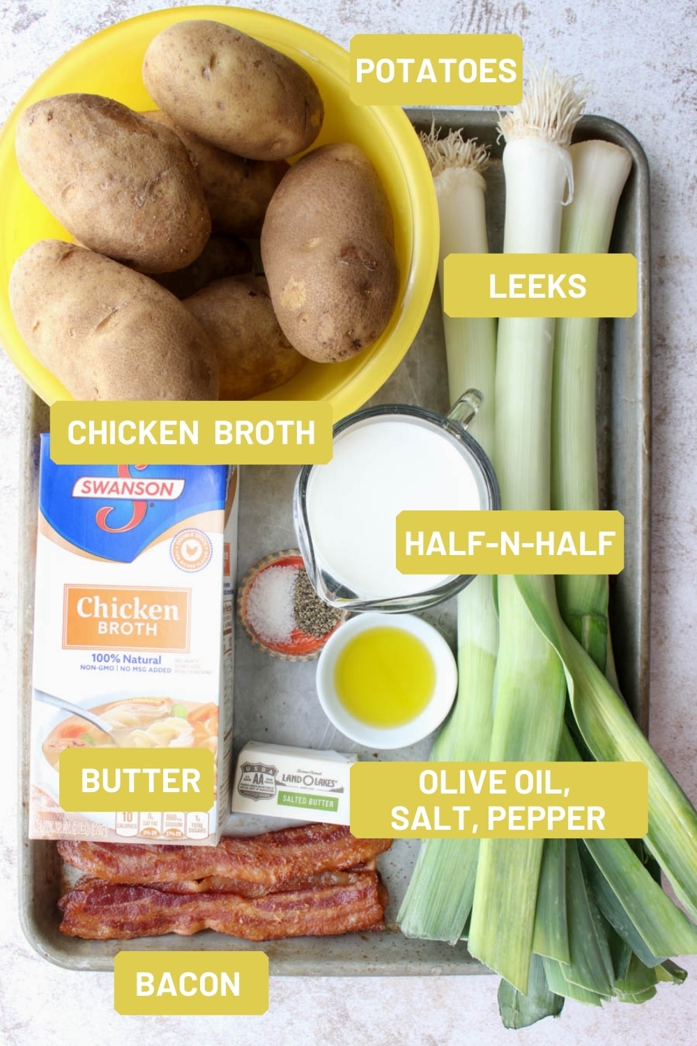 Cookie sheet with the ingredients needed to make potato leek soup