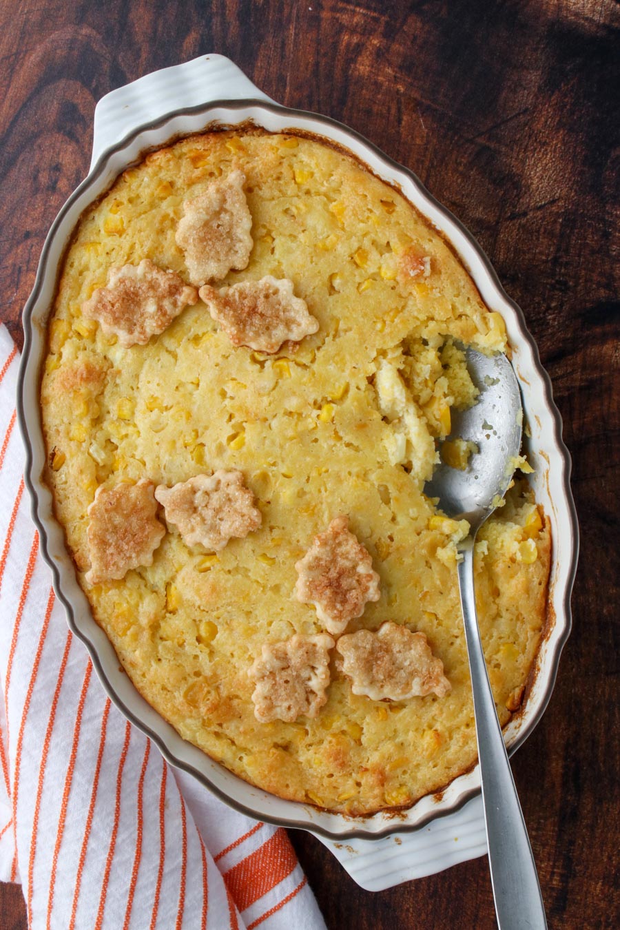 Cornbread pudding casserole with a spoon