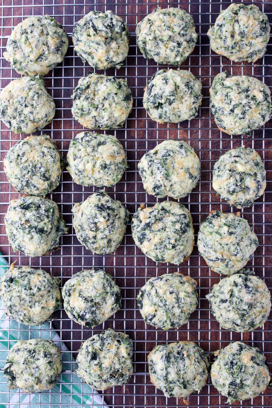 Spinach cheese bits on a cooling rack