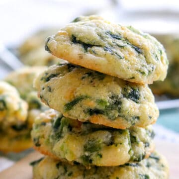 four spinach cheese bites stacked on top of each other