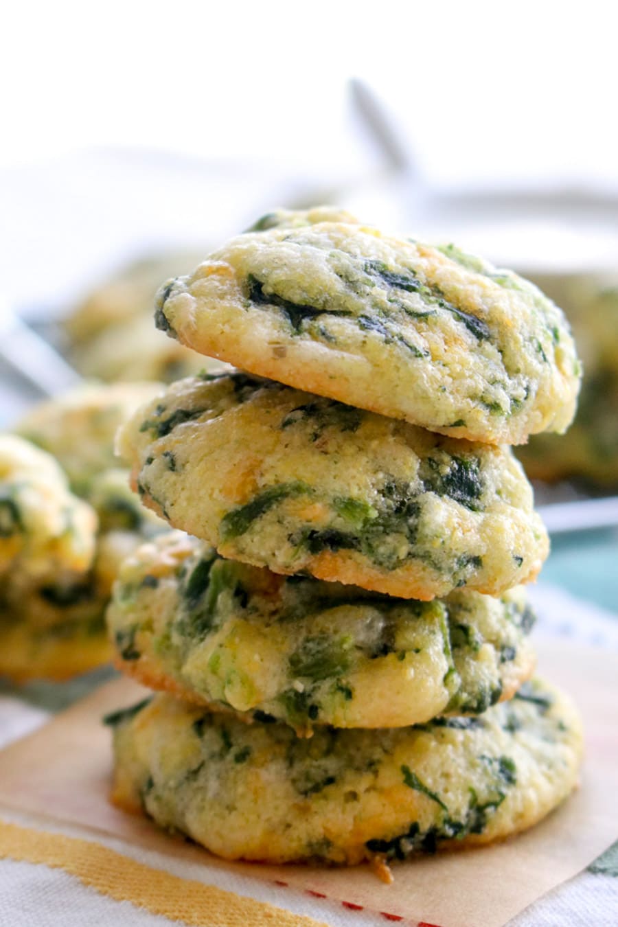 four spinach cheese bites stacked on top of each other