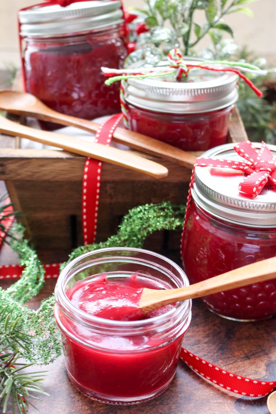 1 open jar of cranberry apple butter and 3 closed jars