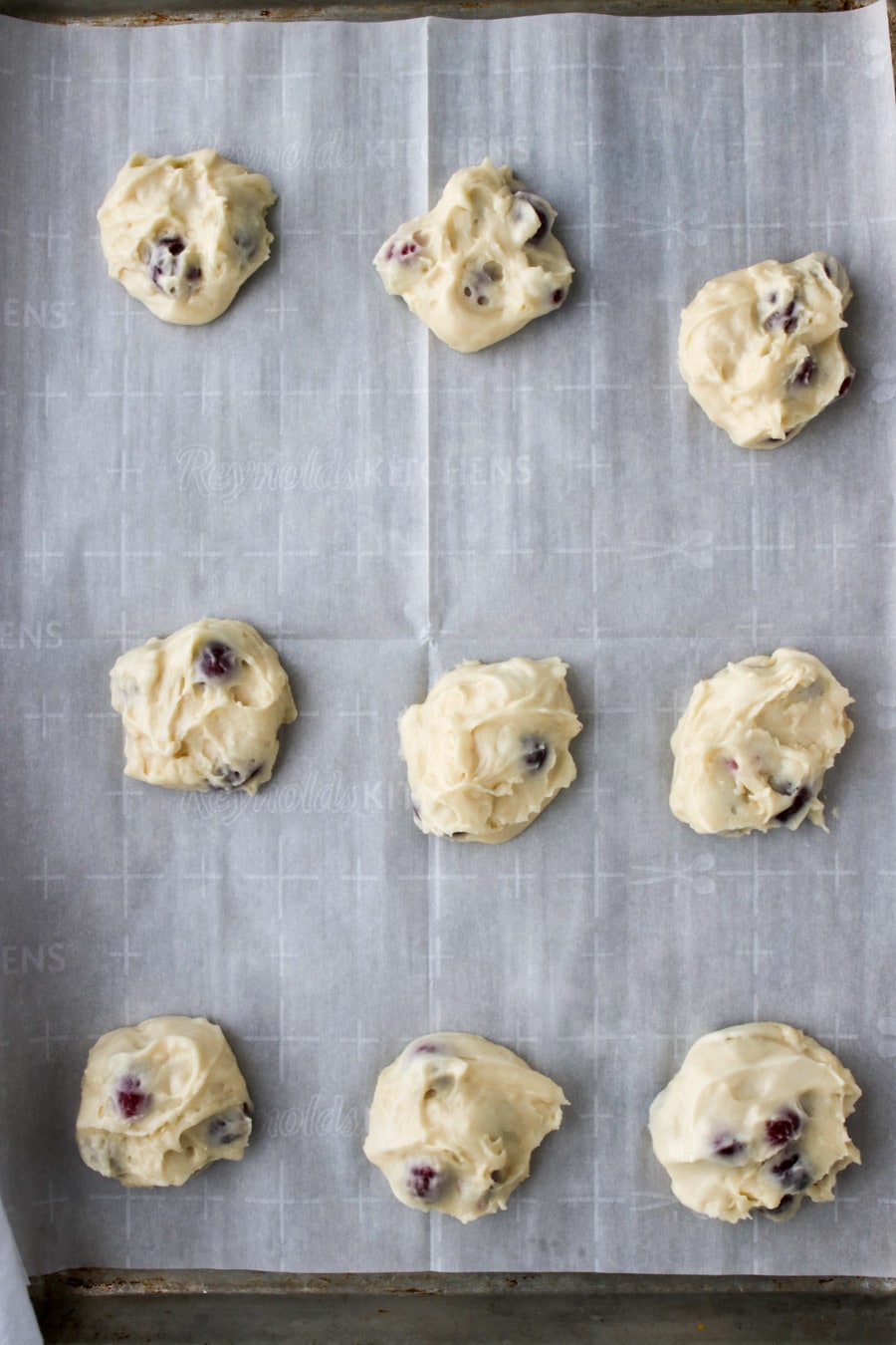 muffins on a cookie sheet ready to go into the oven