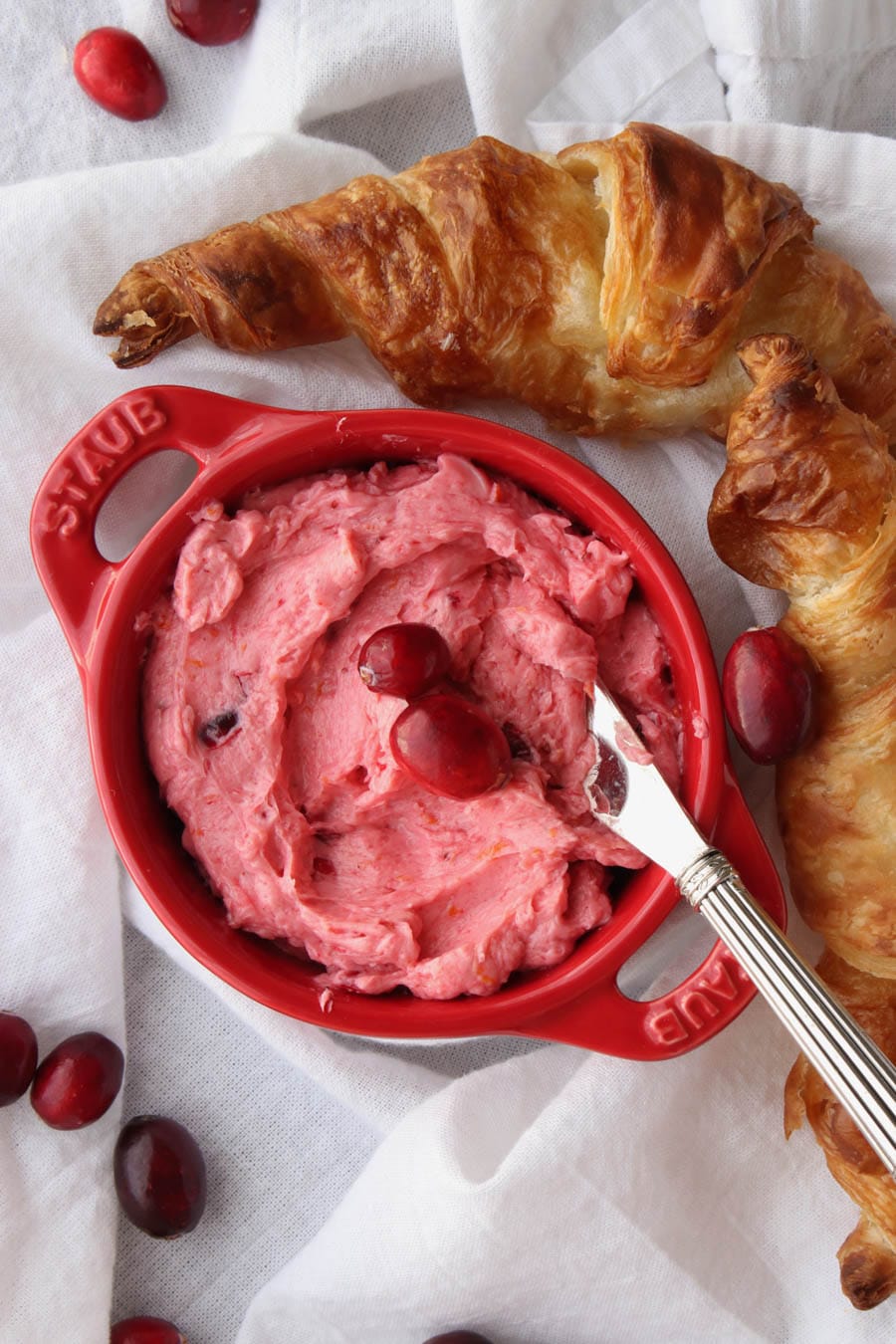 red dish with cranberry butter and croissants 