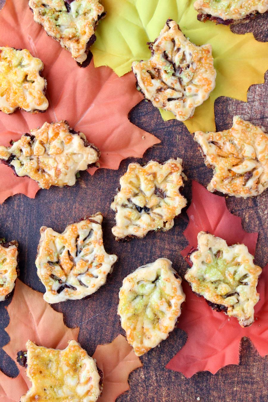 leaf shaped cookies spread out over fall colored leaves