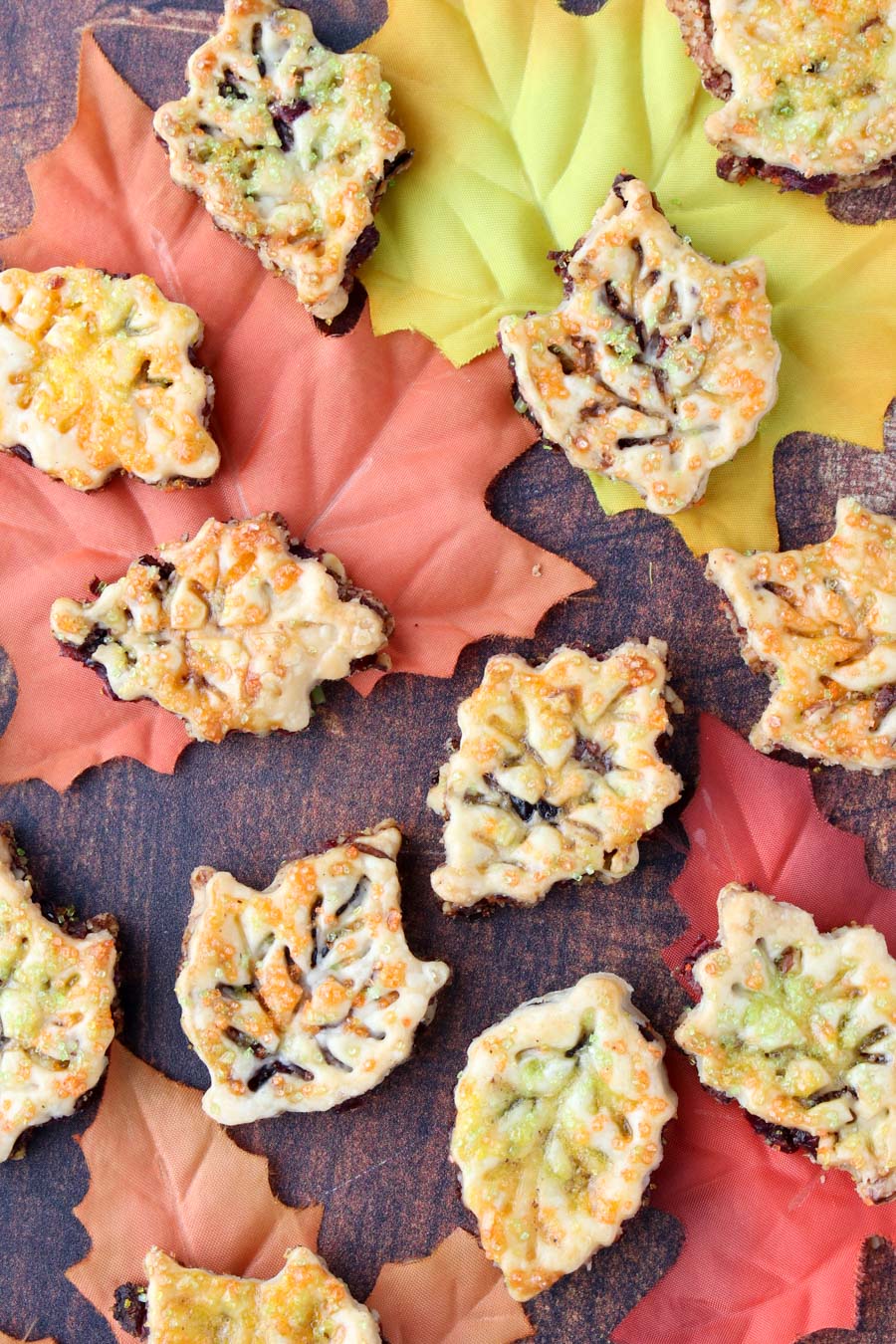 leaf shaped cookies spread out over fall colored leaves