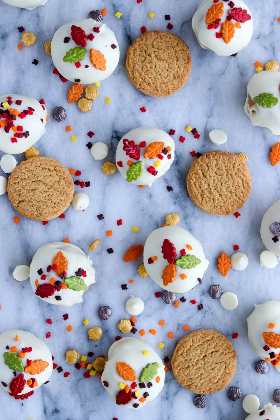 Cookies and sprinkles spread out on a marble background