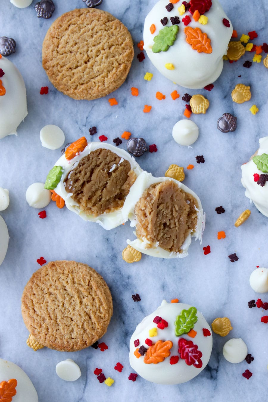 Cookie cut in half with  sprinkles spread out on a marble background