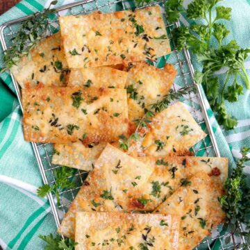 wonton crackers on a silver sire rack with a green and white checked cloth