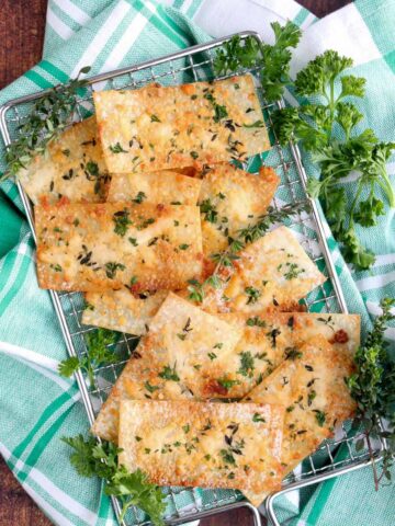 wonton crackers on a silver sire rack with a green and white checked cloth