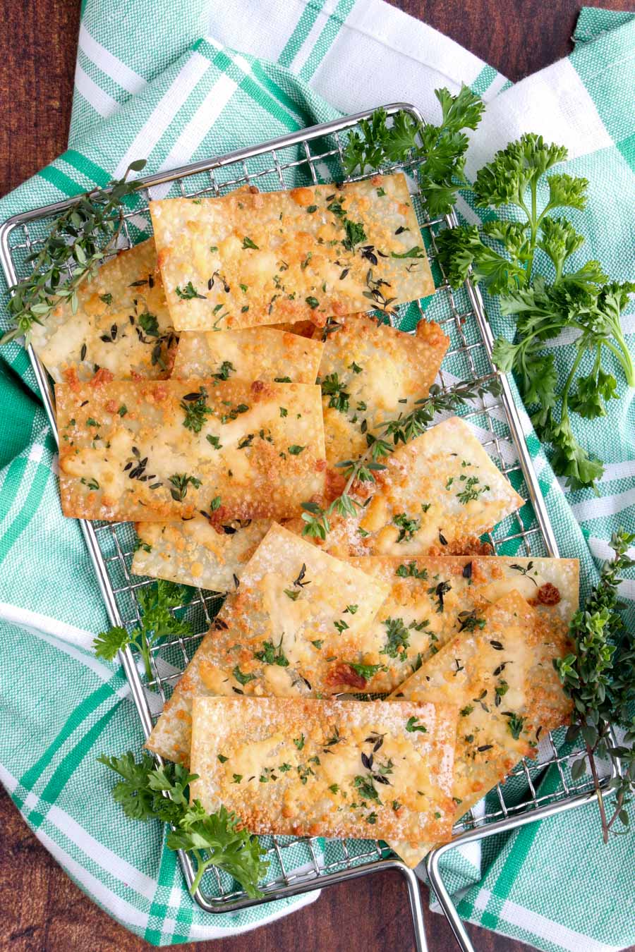 wonton crackers on a silver sire rack with a green and white checked cloth