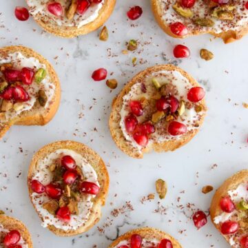 Pistachio pomegranate crostini on a marble slab