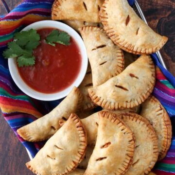 basket of empanadas and a bowl of salsa