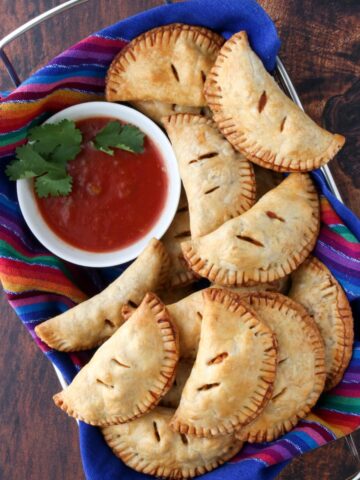 basket of empanadas and a bowl of salsa